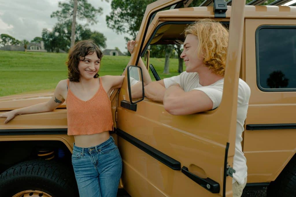 A man and a woman outside the car