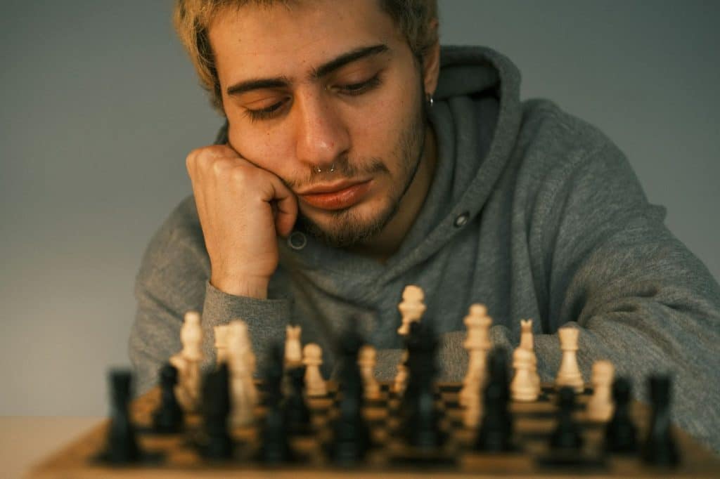 A man out of focus playing a chess
