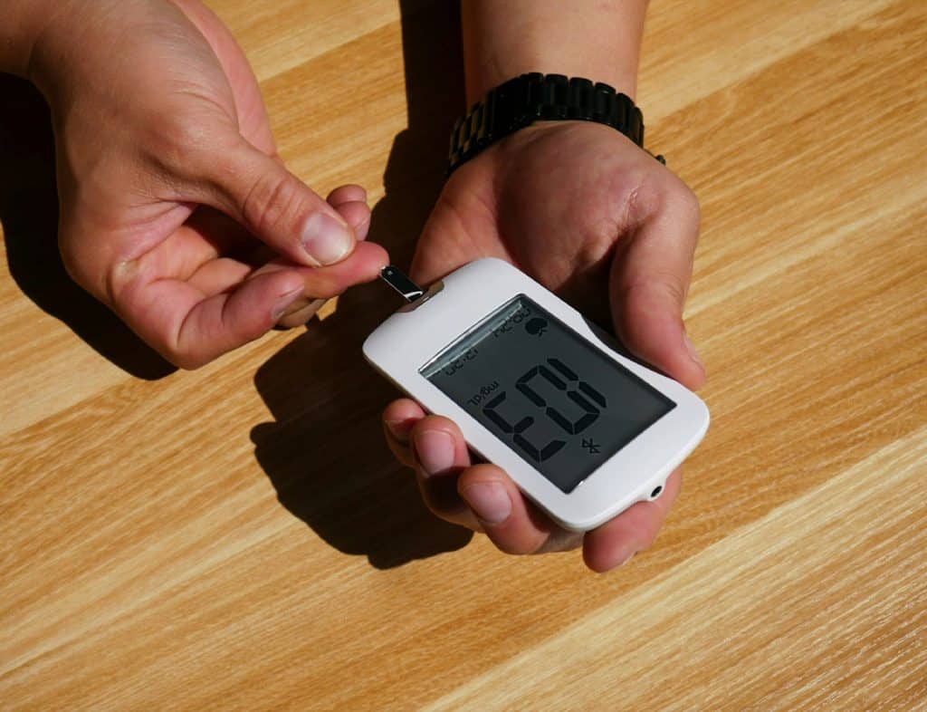A person checking a blood sugar level 