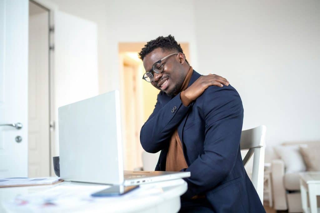 A man reaching his back