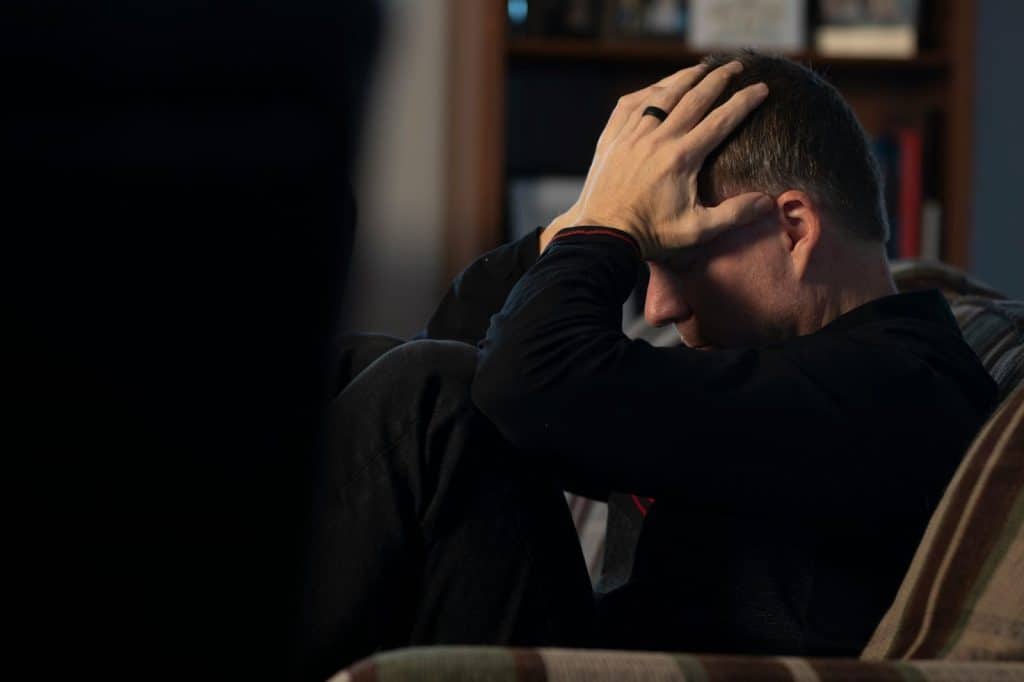 A picture of a man holding his head