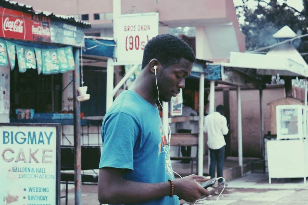 A man with his earphones while walking