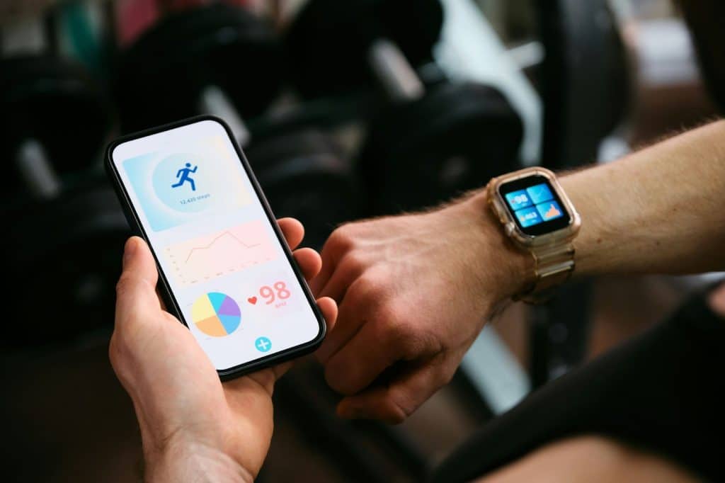 A man with a habit tracker on his phone and watch