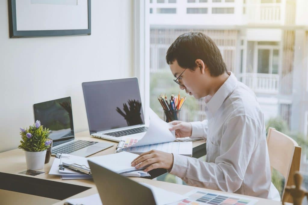A man checking two papers