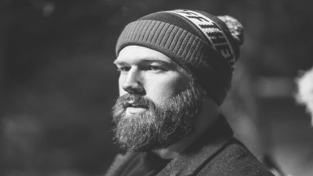 A close up photo of a man with facial hair.