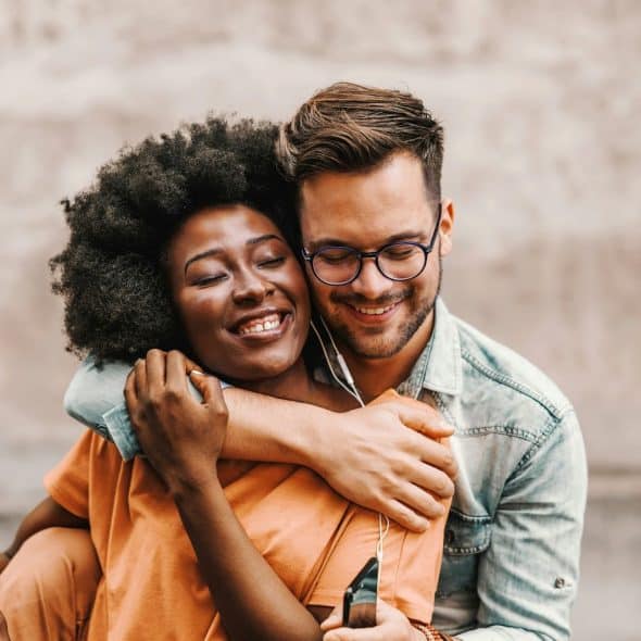 A man hugging a woman