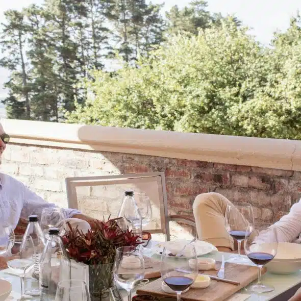 Two men sitting at a table with wine glasses.