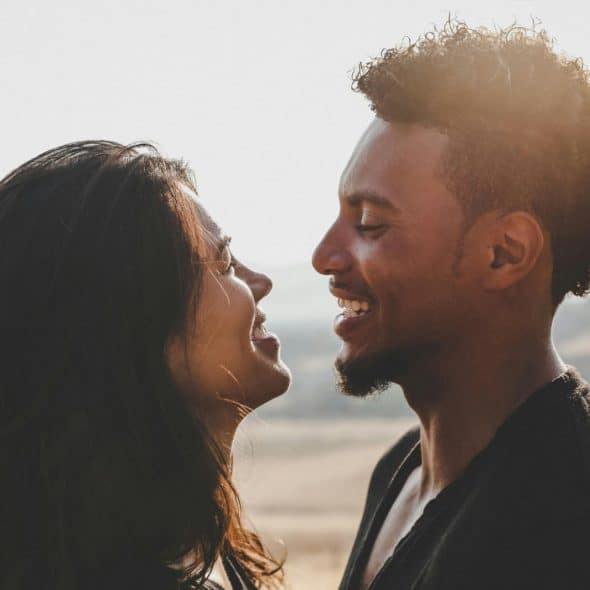 A man and woman smiling at each other