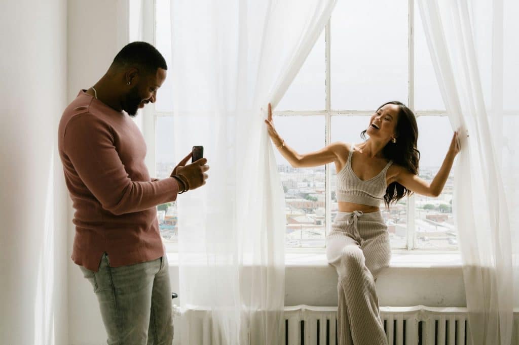A man taking a picture of a woman