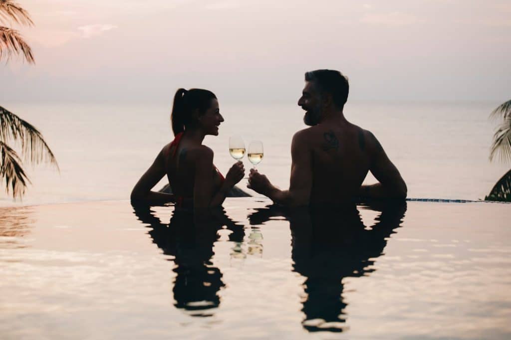 A man and woman with a champagne on their hand
