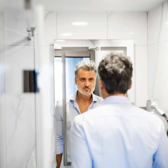 A man looking at the mirror