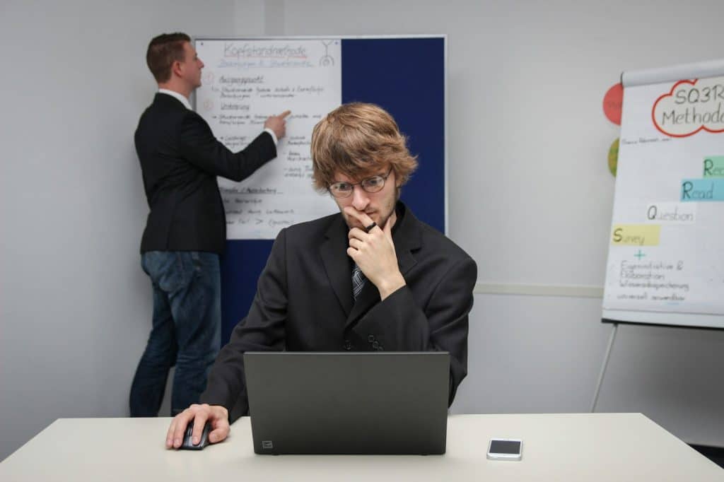 A man focusing on a laptop instead of arguing 