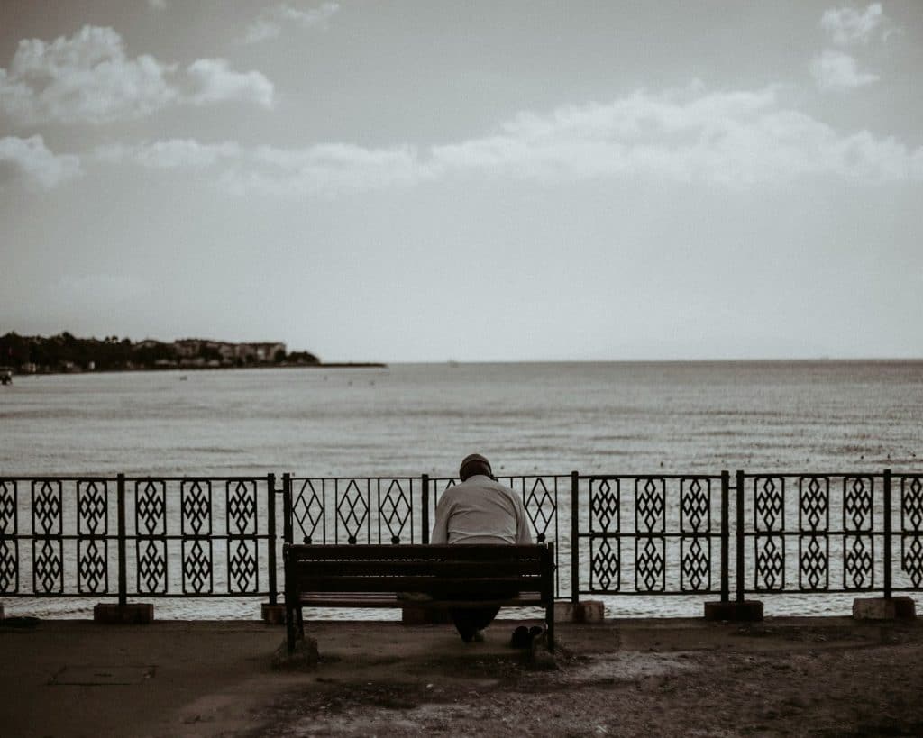 A man sitting alone at the bench