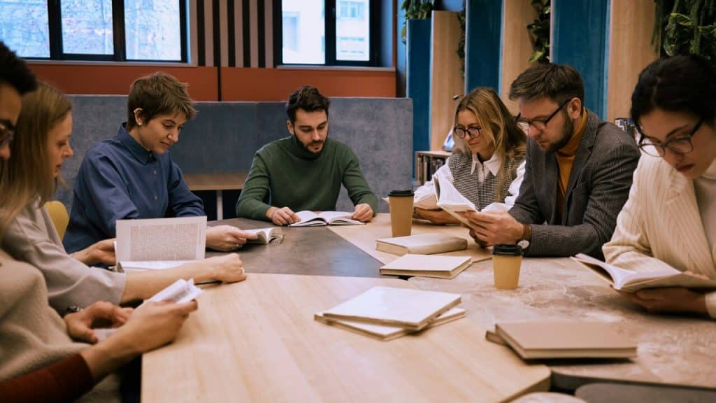A group of people reading together.
