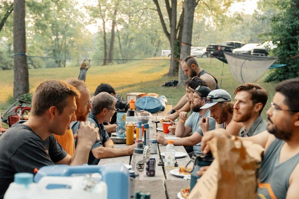 A group of men eating.