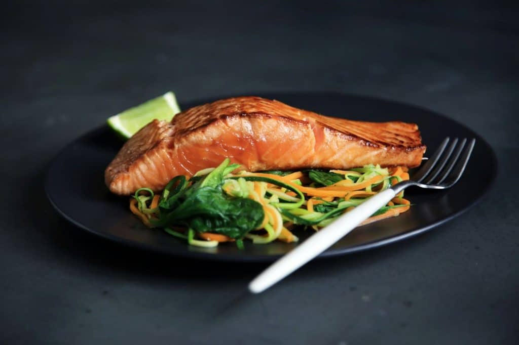 A picture of a salmon on a plate.