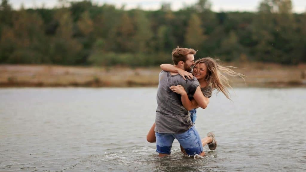 A couple hugging and laughing in the lake