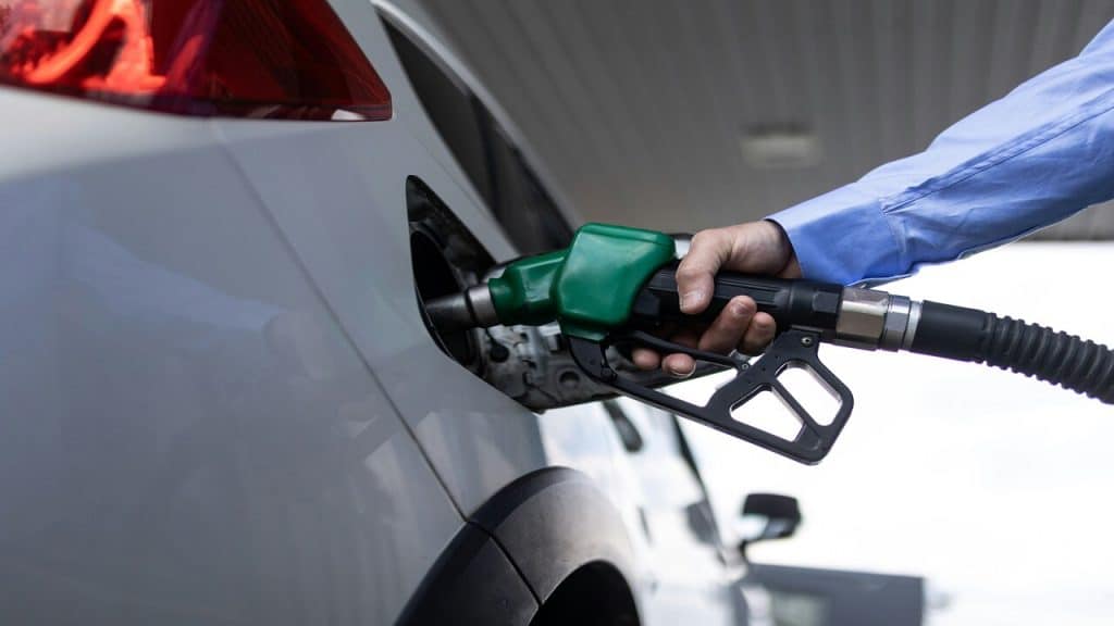 Hand-refilling the car with fuel