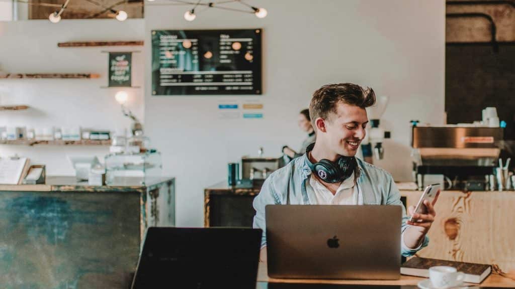 A man smiling at his phone.