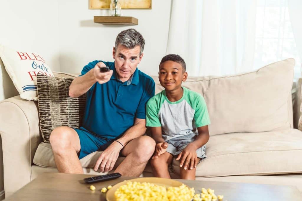 A picture of a man watching with a kid