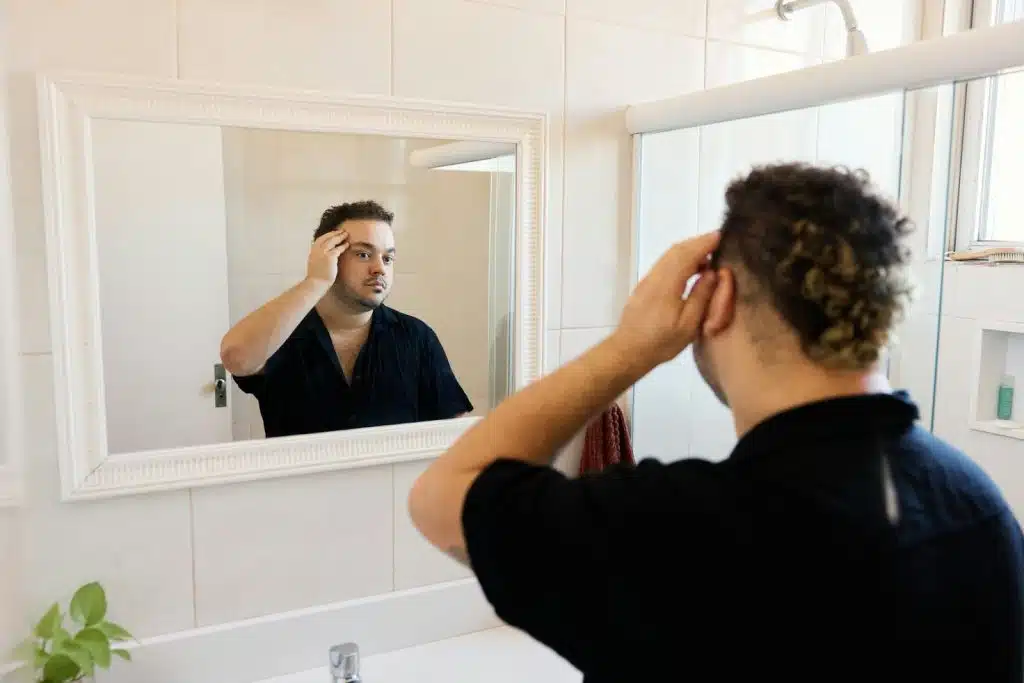 A picture of a man looking at the mirror to represent identity of self