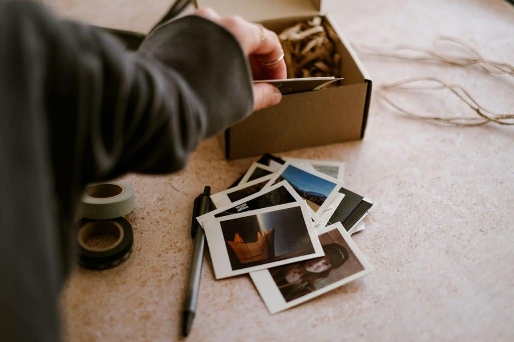 A person getting a picture out from the box to represent a “memory”.