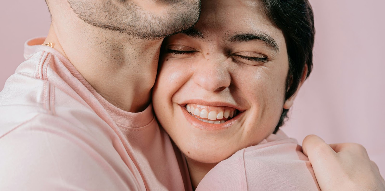 A man hugging a smiling woman.