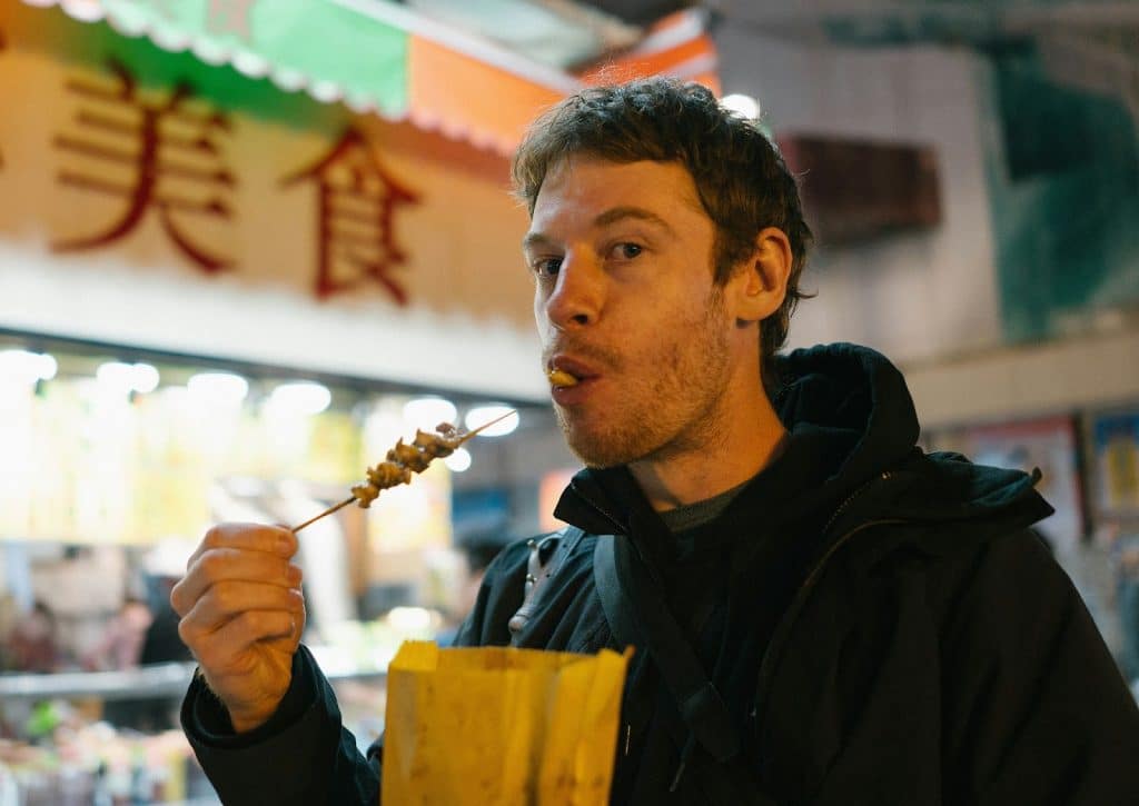 A man eating a street food.