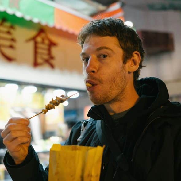 A man eating a street food.