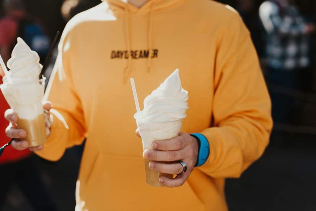 A man holding two icecreams.