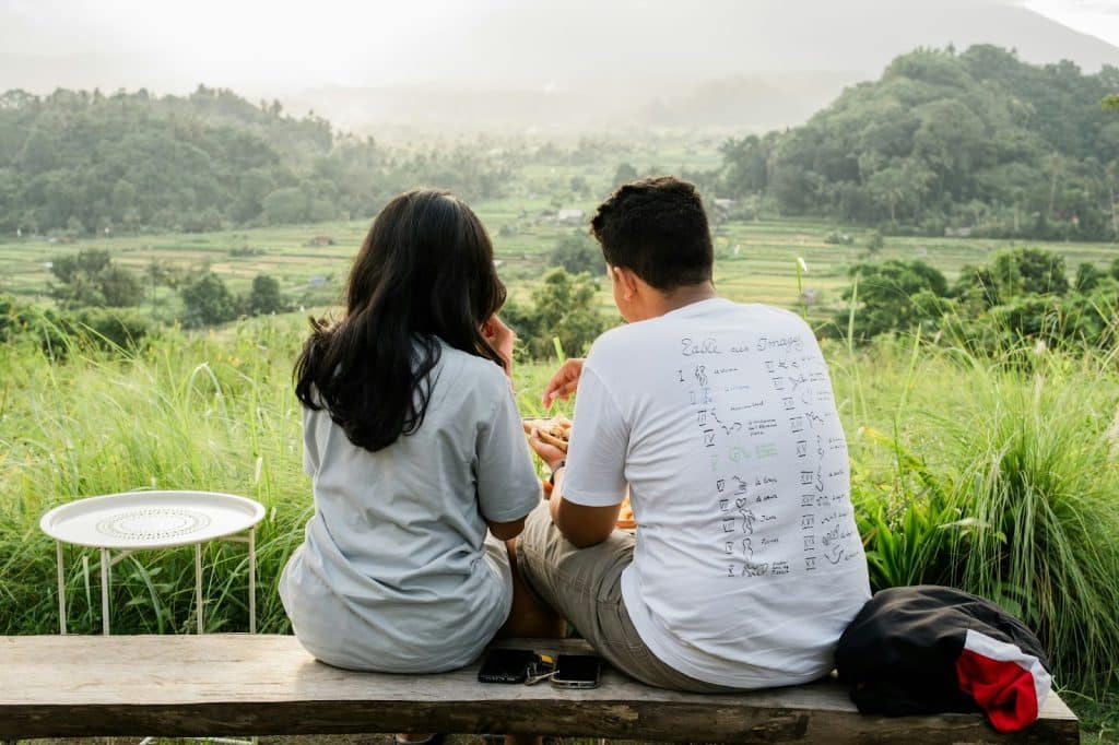 A couple bonding in front of a beautiful view.