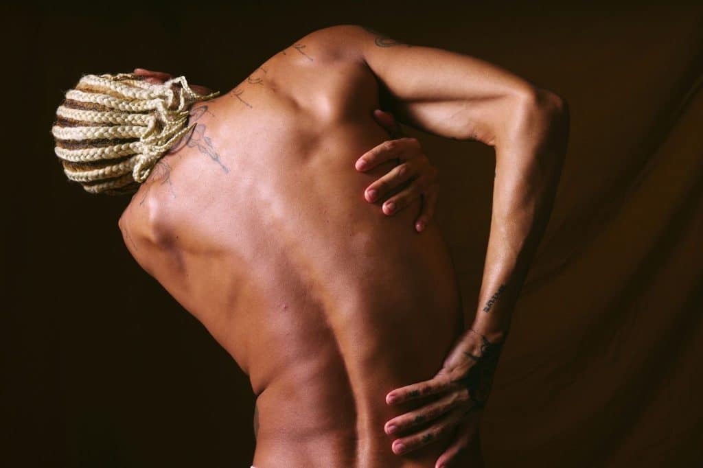 A man reaching his back and suffering from a back pain.