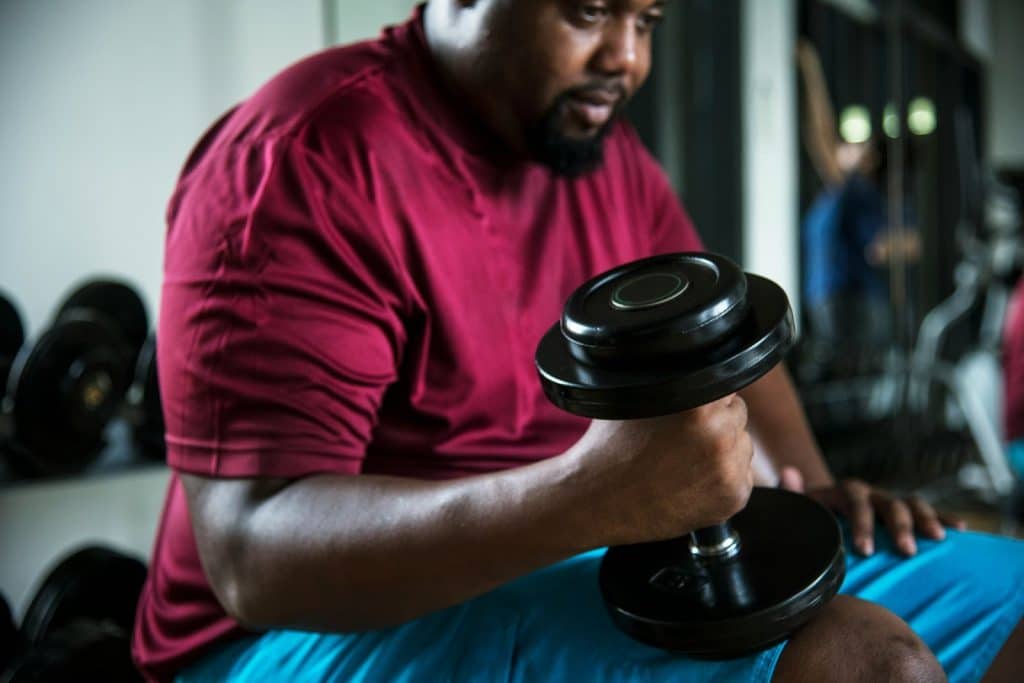 A man holding a dumbbell.