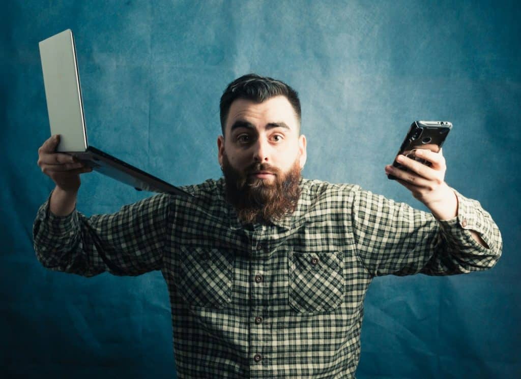 A man holding gadgets.