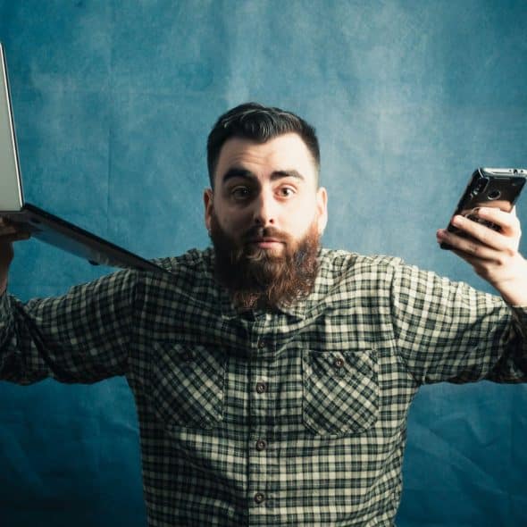 A man holding gadgets.