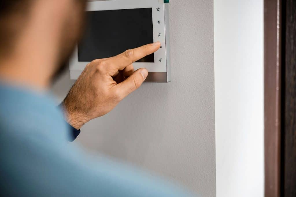 A man clicking on a technology for a house.