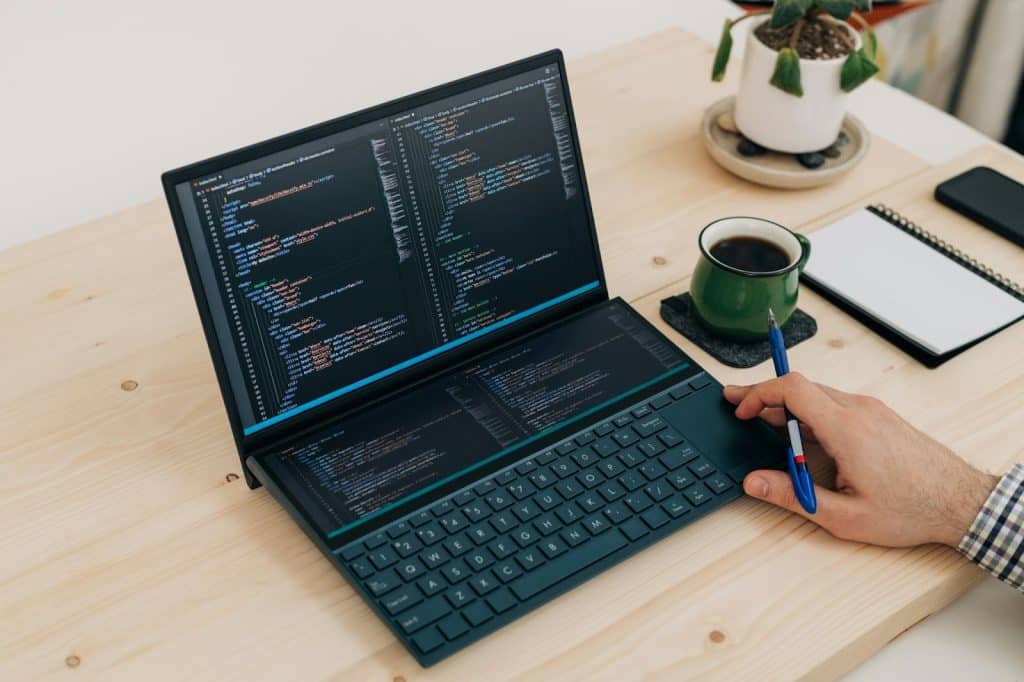 A man checking a laptop’s software.