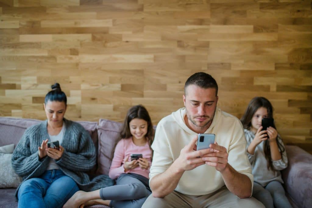 A group of people using a phone.