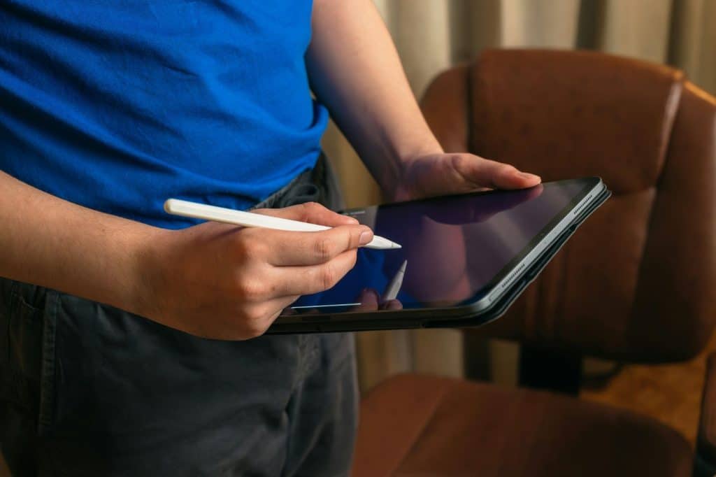 A man a pen and a tablet.