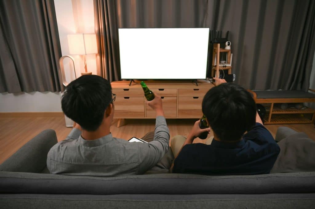 Two men watching a movie.
