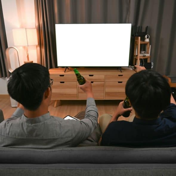 Two men watching a movie.