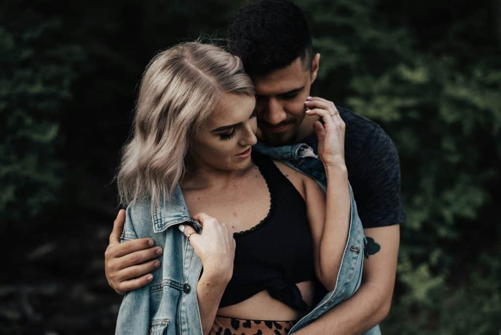 A man hugging a woman from behind.