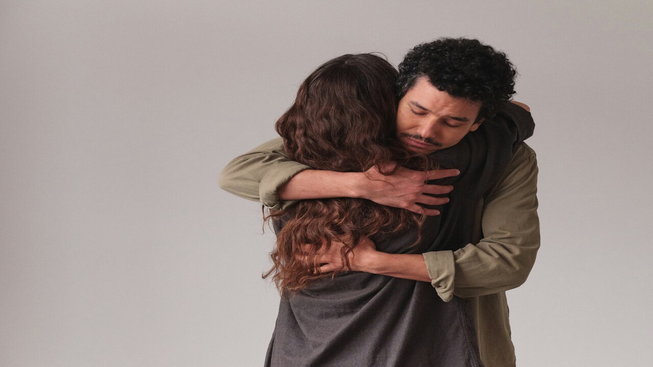 A couple hugging and comforting each other.