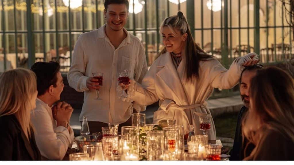 A man with relaxed posture at a social event, chatting naturally