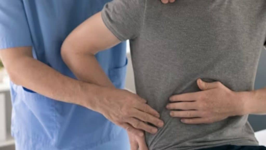 Man in the hospital complaining  pain in the kidney part of his body.