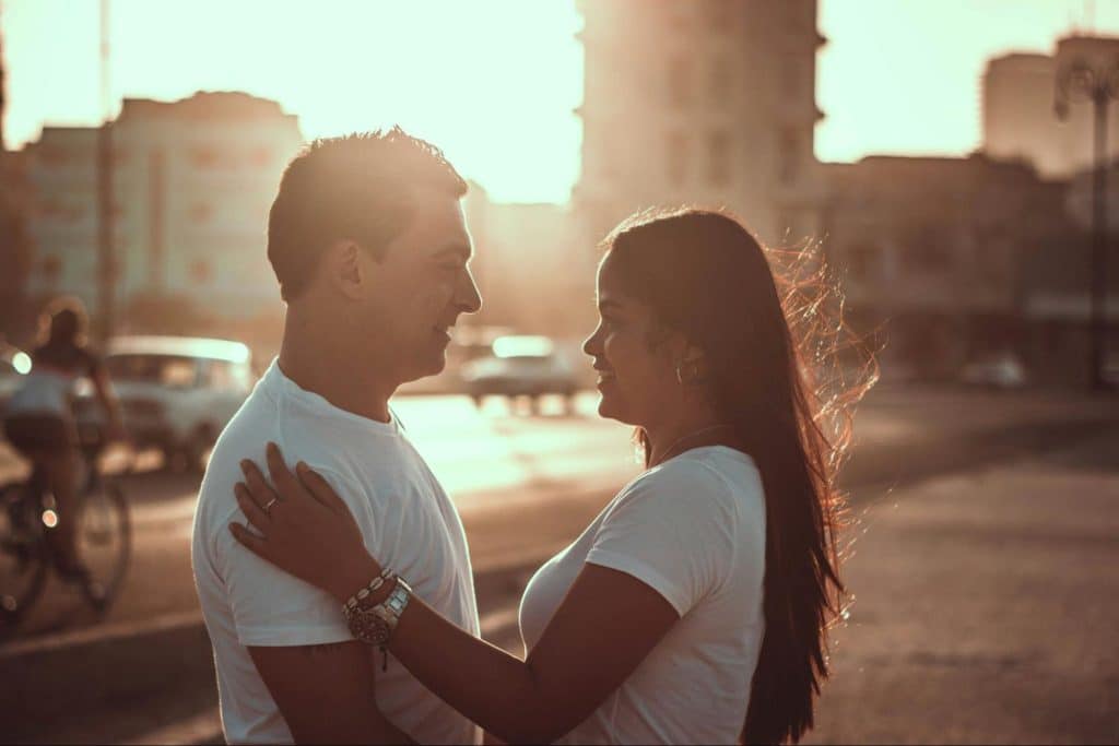 A man and woman facing each other 
