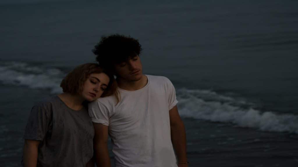 A couple looking sad at the beach