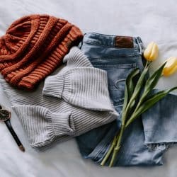 A casual outfit laid on a bed