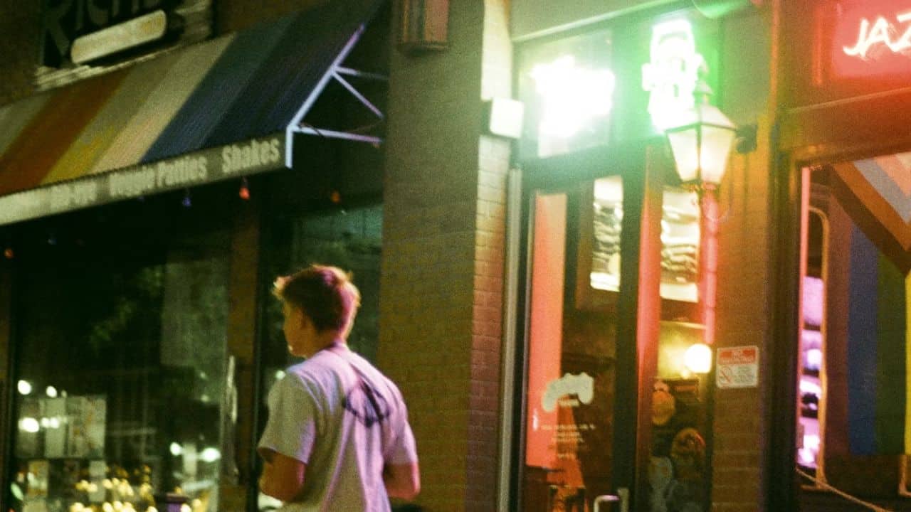 A man leaving a bar, choosing to walk away from unhealthy coping habits.