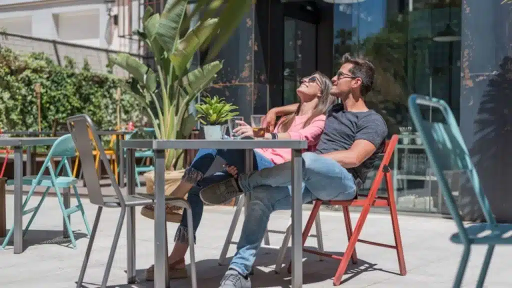 Couple sitting outdoors with no devices in sight.
